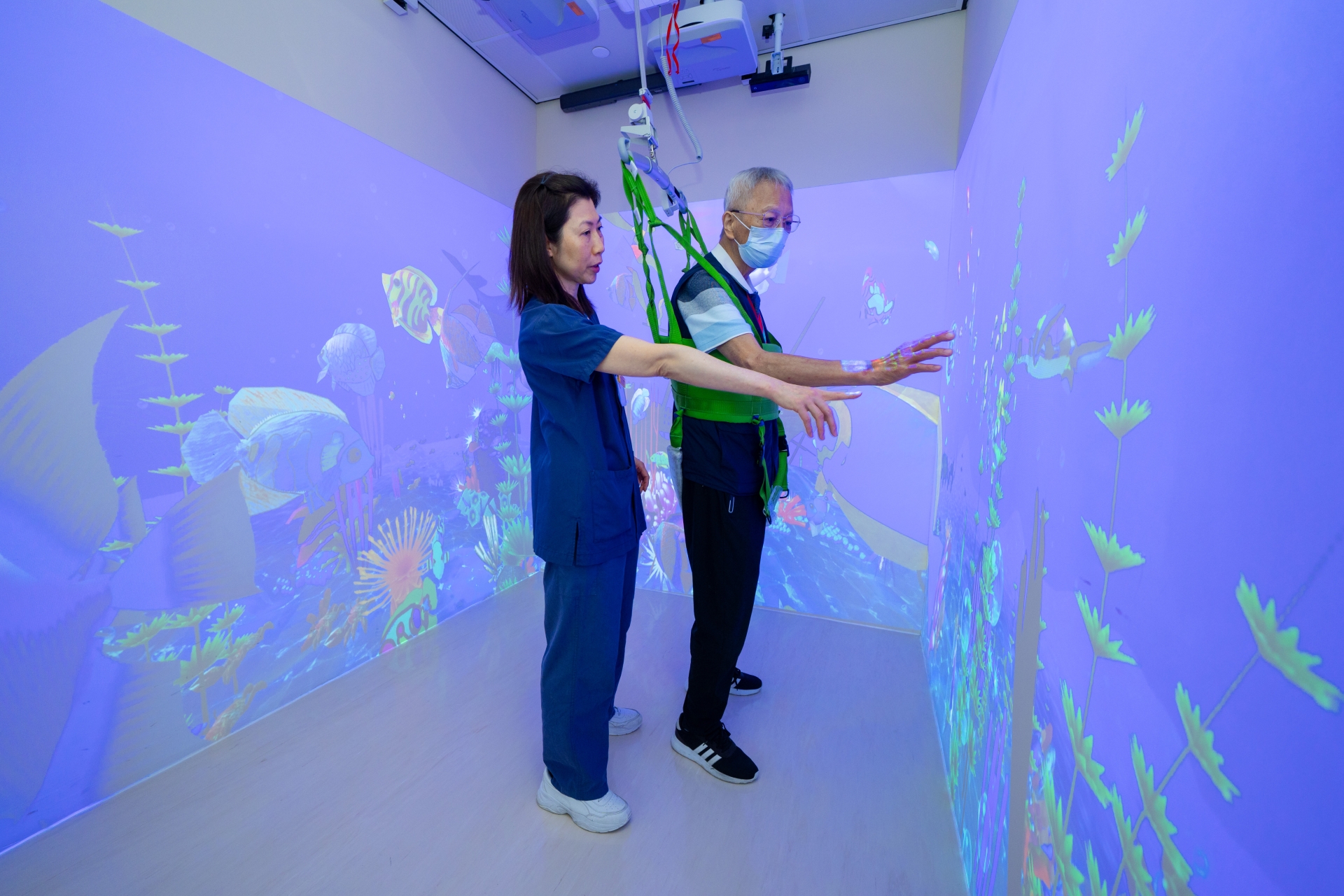 The 'fish' coloured by Mr Li (right) is projected onto the AR-CAVE environment and becomes the target of his fish-catching.
